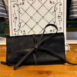 Chic Black Leather Jewelry Roll with Bow Accent